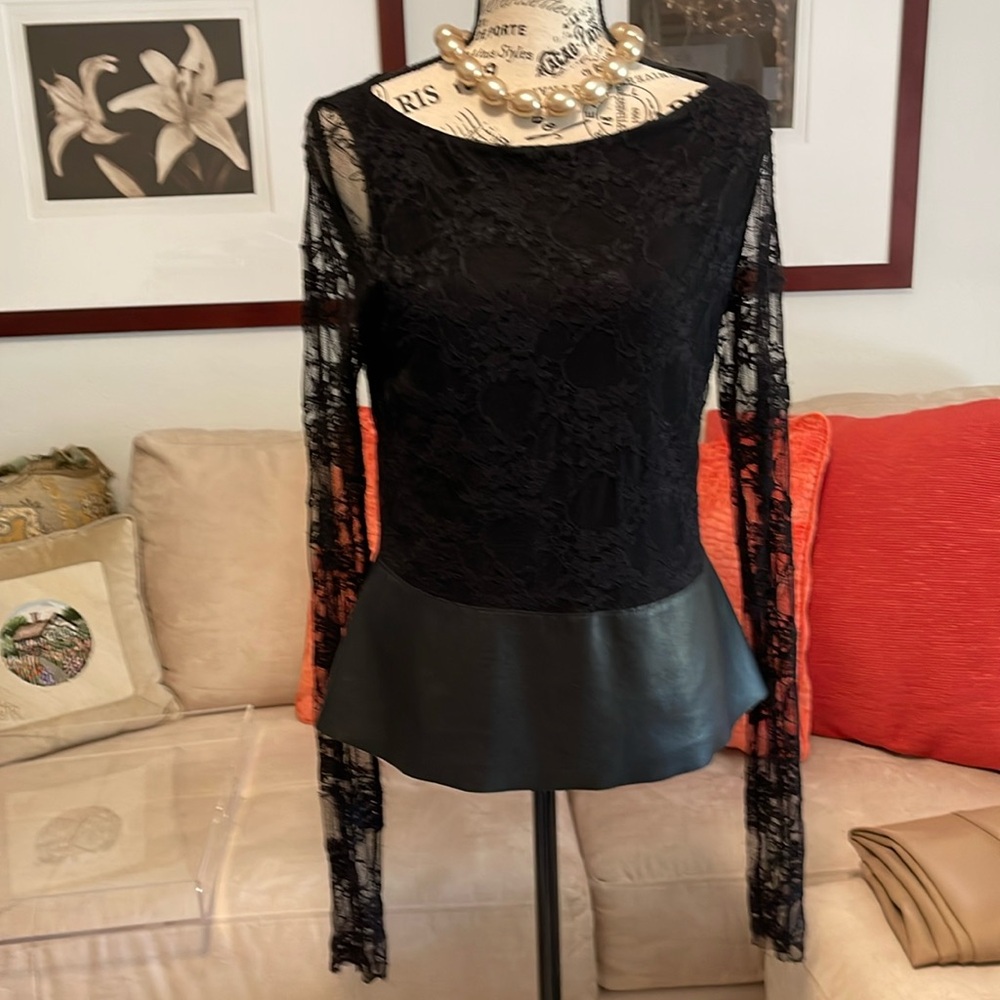 Black stretchy lace & leather peplum, jewel neck blouse by ‘Bailey 44.’